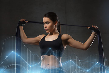 Image showing woman with expander exercising in gym