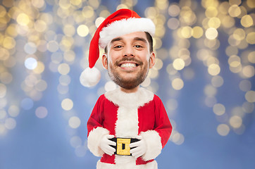 Image showing man in santa claus costume over christmas lights