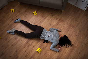 Image showing dead woman body in blood on floor at crime scene