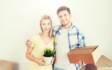 Image showing smiling couple with big boxes moving to new home