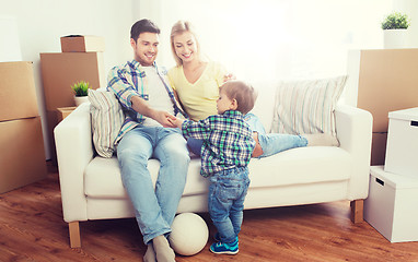 Image showing happy family moving to new home and playing ball