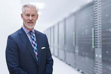 Image showing Senior businessman in server room