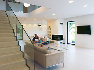 Image showing young happy couple relaxes in the living room