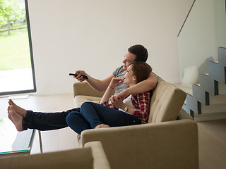 Image showing Young couple on the sofa watching television