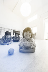 Image showing boys having fun with an apple on the floor