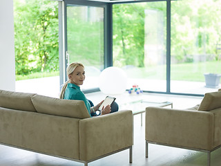 Image showing woman on sofa using tablet computer