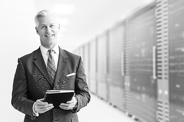 Image showing Senior businessman in server room