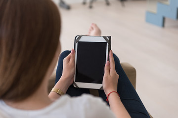 Image showing woman sitting on sofa with tablet computer