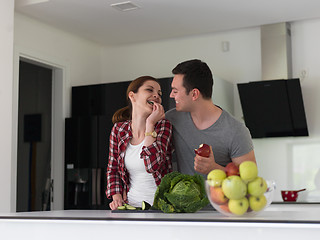 Image showing Young handsome couple in the kitchen