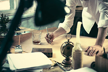 Image showing Architect working on drawing table in office