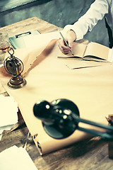 Image showing Architect working on drawing table in office