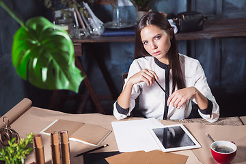 Image showing Young beautiful woman working with cup of coffee