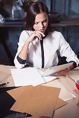 Image showing Young beautiful woman working with cup of coffee