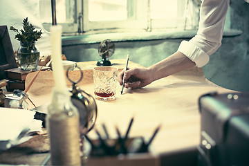 Image showing Architect working on drawing table in office