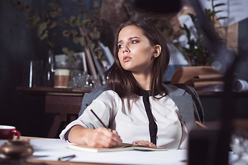 Image showing Architect working on drawing table in office