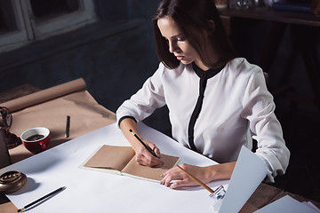 Image showing Architect working on drawing table in office