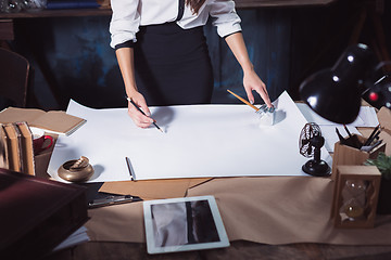 Image showing Architect working on drawing table in office