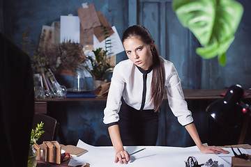 Image showing Architect working on drawing table in office