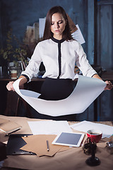 Image showing Architect working on drawing table in office