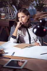 Image showing Architect working on drawing table in office