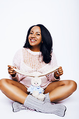 Image showing young pretty african american woman pregnant happy smiling, posing on white background isolated , lifestyle people concept copyspace