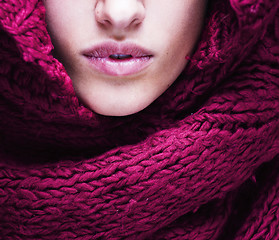 Image showing young pretty woman lips in sweater and scarf all over her face