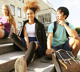 Image showing cute group of teenages at the building of university with books huggings, back to school