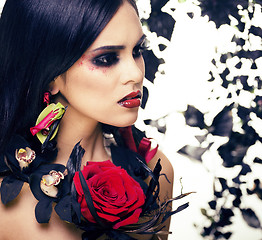 Image showing pretty brunette woman with rose jewelry, black and red, bright m