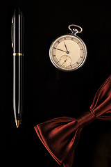 Image showing Pocket watch, pen and bow-tie are men's accessories