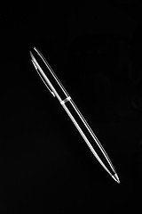 Image showing Black ballpoint pen on a black background