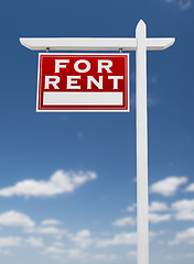 Image showing Left Facing For Rent Real Estate Sign on a Blue Sky with Clouds.