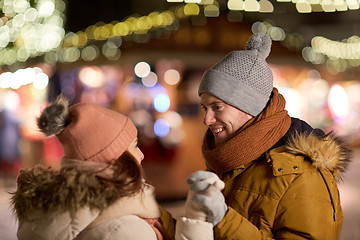 Image showing happy couple holding hands at christmas market