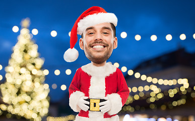 Image showing man in santa claus costume over christmas lights