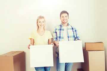 Image showing smiling couple with big boxes moving to new home