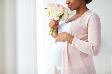 Image showing happy african american pregnant woman with flowers