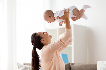 Image showing happy mother playing with little baby boy at home