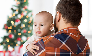 Image showing close up of happy baby with father at christmas