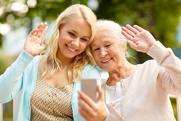 Image showing daughter and senior mother taking selfie at park