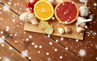 Image showing citrus, ginger, garlic and rowanberry on wood