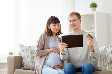 Image showing husband and pregnant wife shopping online at home