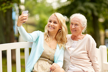 Image showing daughter and senior mother taking selfie at park