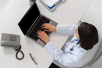 Image showing woman doctor typing on laptop at clinic