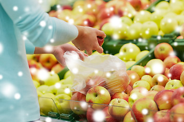 Image showing woman with bag buying apples at grocery store