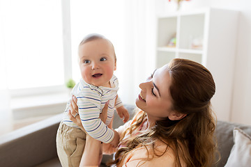 Image showing happy young mother with little baby at home