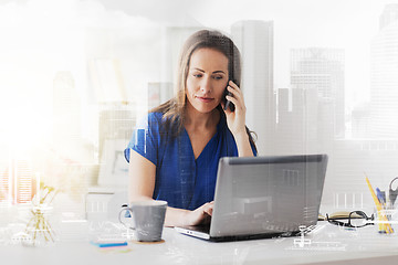 Image showing woman calling on smartphone at office