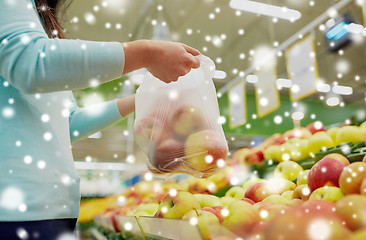 Image showing woman with bag buying apples at grocery store