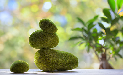 Image showing Balanced stones with moss