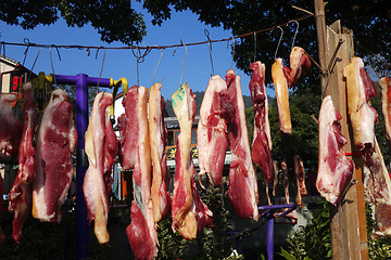 Image showing The suspended pieces of the meat drying outside