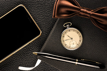 Image showing Men's accessories are watch, pen, phone and bow-tie