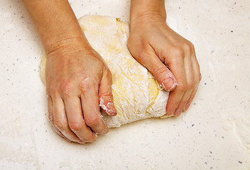 Image showing cook kneads dough for bread